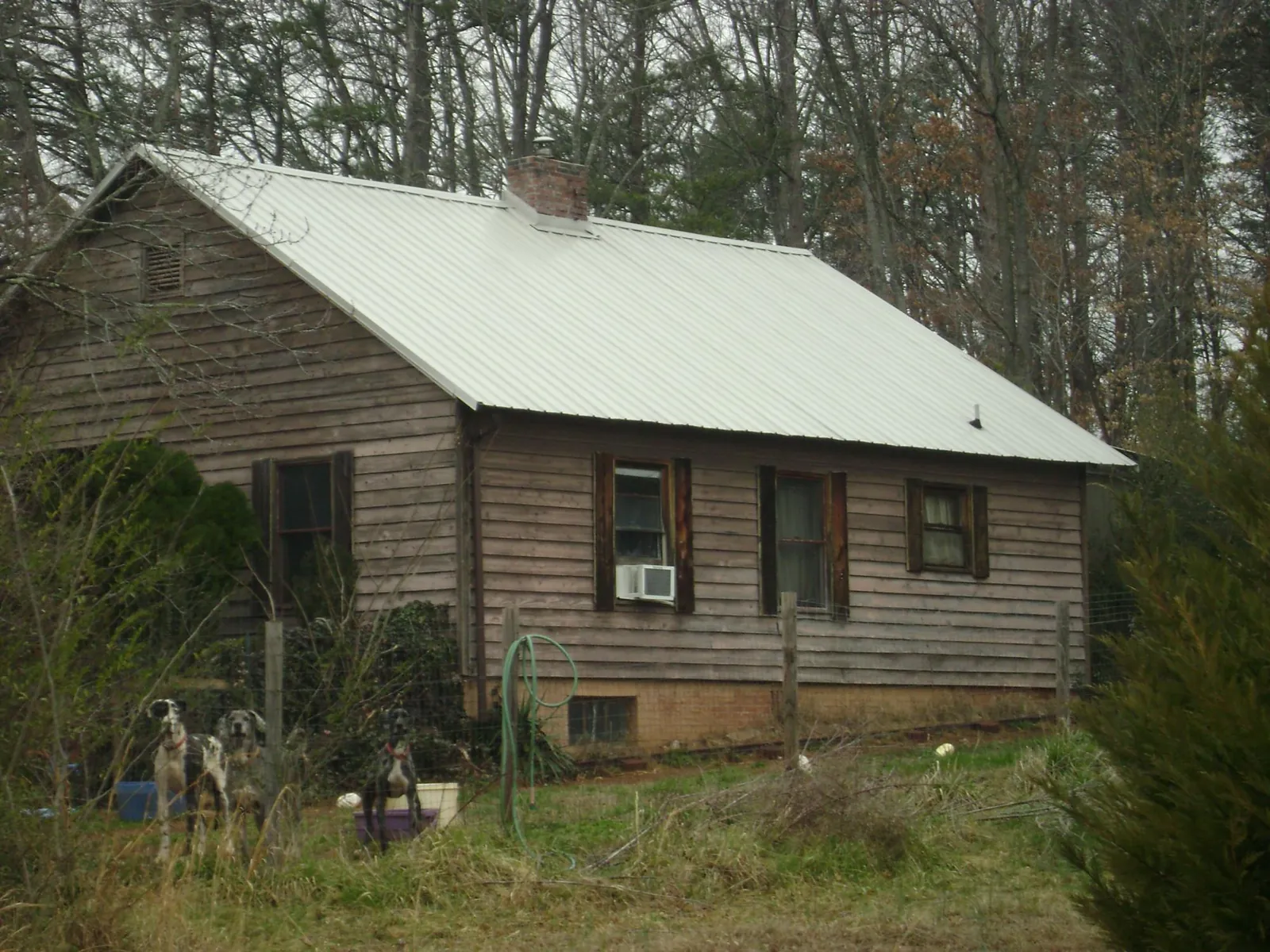 White metal roof on an old wood sided farmhouse, from a Metal Roof Installation job in Streator
